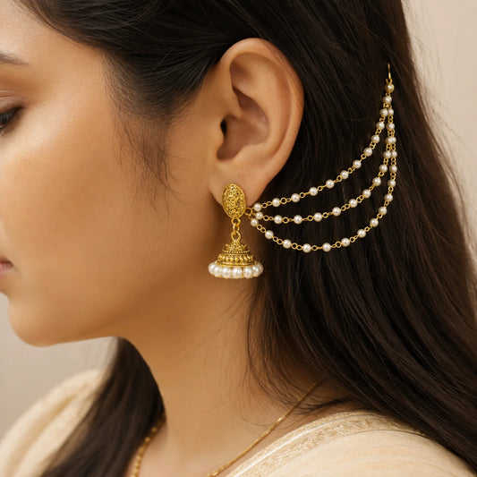 "Antique gold-tone pearl
 jhumka earrings with intricate traditional detailing and white pearl accents. Elegant ethnic jhumka earrings for women, perfect for weddings, festive celebrations, Navratri, Diwali, Haldi, Mehendi, pujas, and traditional Indian wear."

