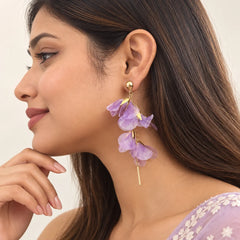 "Pair of gold-tone
 statement earrings featuring cascading layers of delicate lavender and lilac flower petals, accented with fine chains and long slim metal drops."
