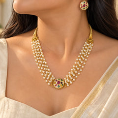 Multistrand pearl necklace set with gold-tone detailing, multicolour stone-studded motifs, and matching stud earrings.
