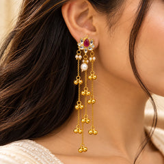 Gold-toned Kashmiri long chain earrings featuring a red lotus motif, clear stones, pearl accents, and dangling gold ghungroo charms.
