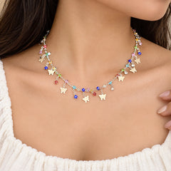 "Silver-toned charm
 necklace featuring multiple white butterfly charms and colourful faceted beads in pink, blue, purple, red, and yellow."
