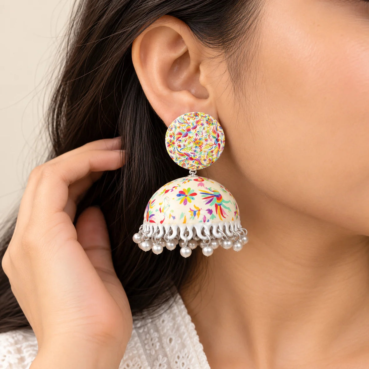 "Pair of  dome-shaped
 jhumka earrings featuring vibrant multicolour floral patterns and delicate white bead danglers around the edges."

