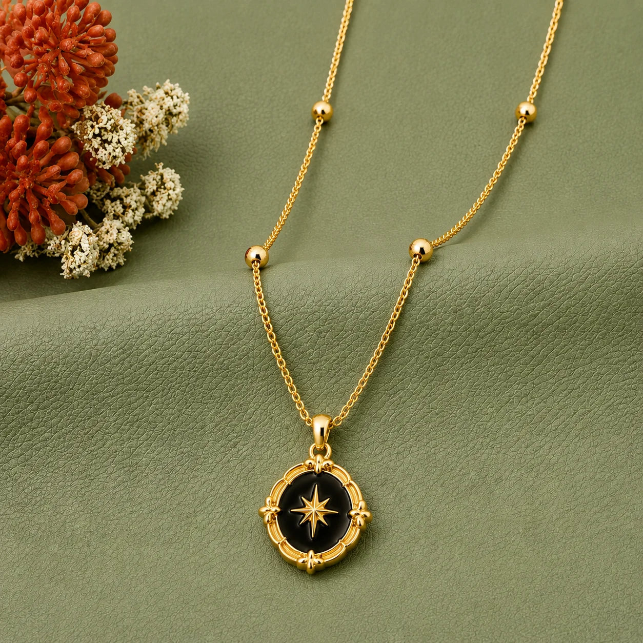 18K gold plated vintage medallion necklace with a black enamel oval pendant and gold north star in the center. The baroque ornate frame gives it a classic, celestial look. Paired with a delicate satellite bead chain for modern daily wear.
