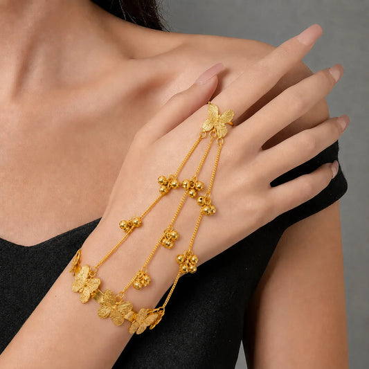 "Gold-tone butterfly haathphool 
with an adjustable finger ring, delicate hand chain, butterfly cuff bracelet, and dangling ghungroo charms. Elegant bridal hand jewellery for women, perfect for weddings, Mehendi, Haldi, Karwa Chauth, Diwali, festive celebrations, and ethnic wear."

