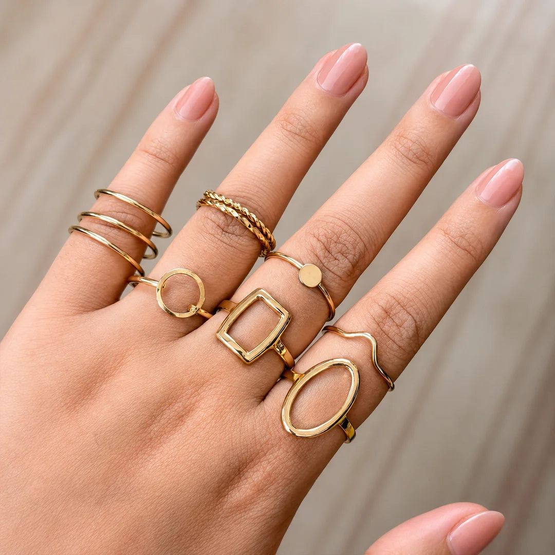 "Golden ring combo for women
 featuring minimalist, geometric and textured stacking rings in assorted modern designs."
