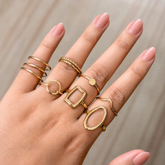 "Golden ring combo for women
 featuring minimalist, geometric and textured stacking rings in assorted modern designs."
