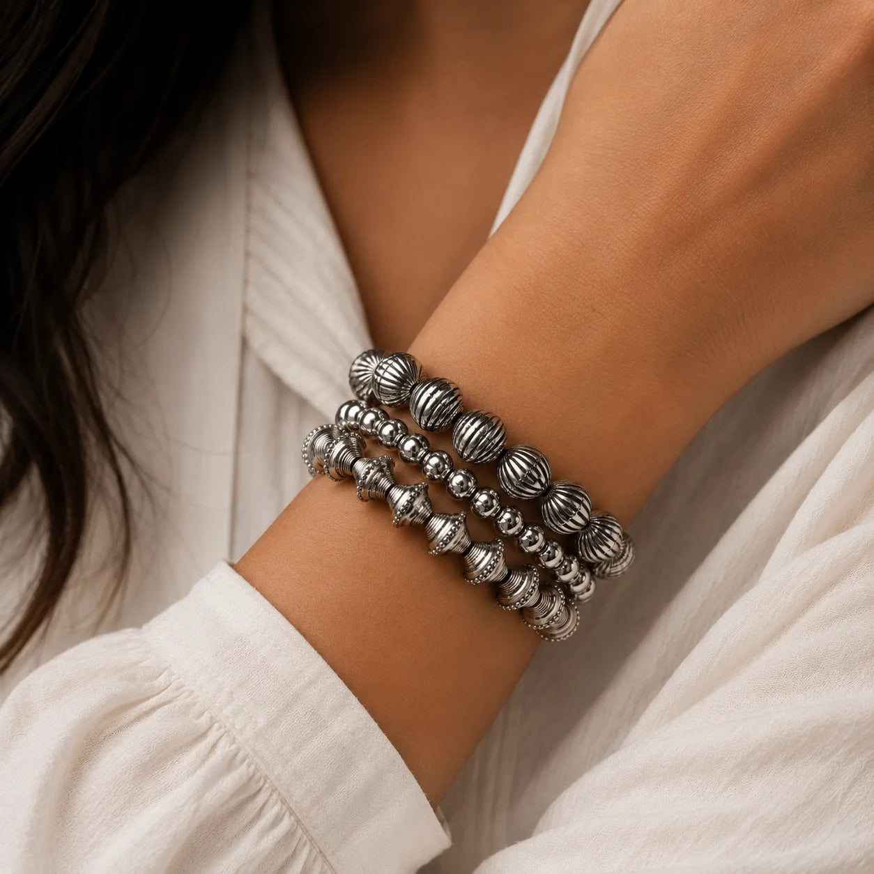 Handcrafted oxidised silver bracelet stack. Set of 3 beaded stretch bangles with carved details. Indo-western daily wear jewellery.
