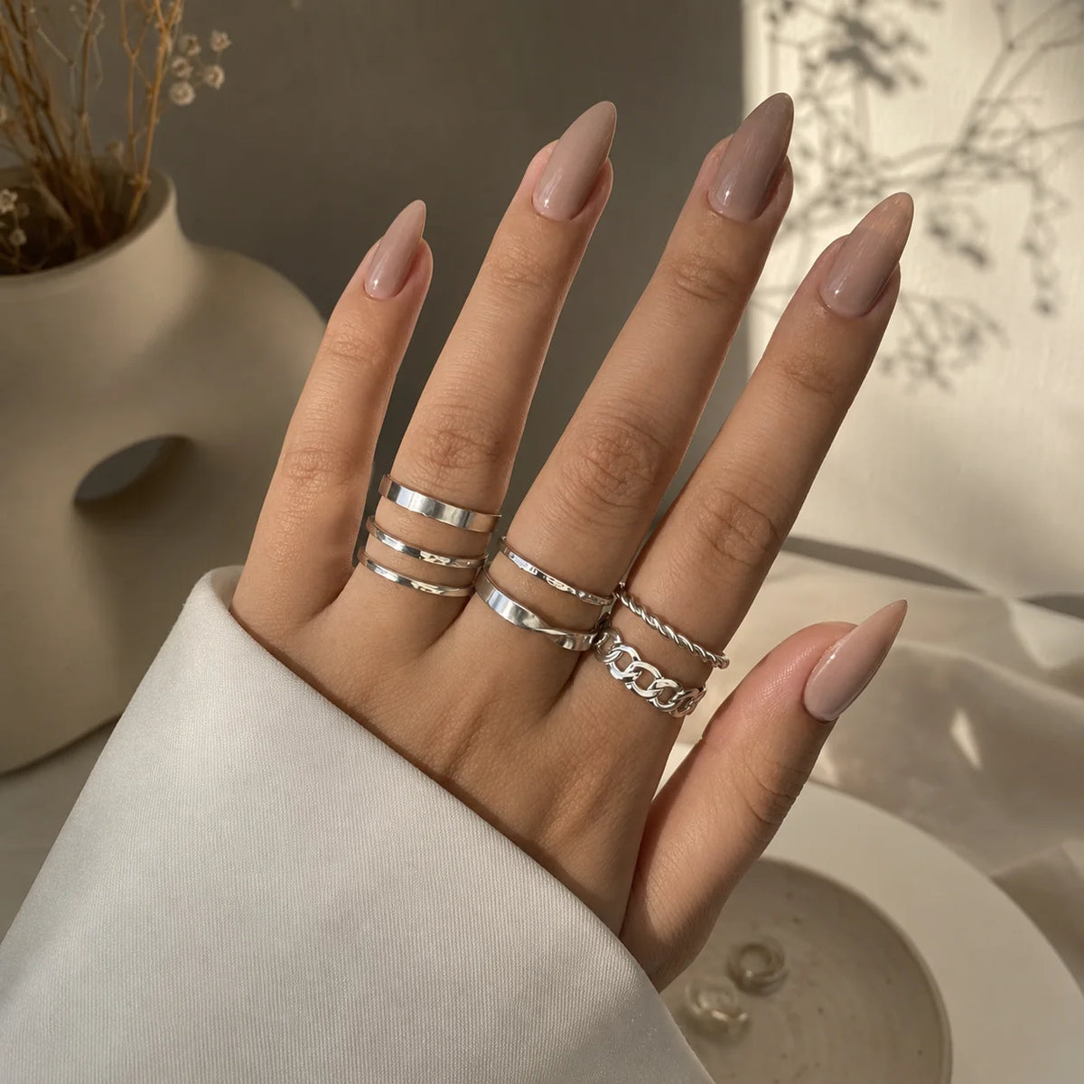 "Silver ring combo for women 
featuring six minimalist, twisted and textured stackable rings in modern designs."

