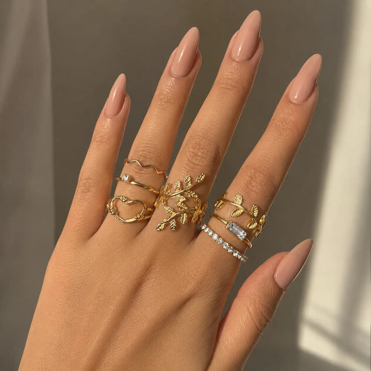 "Golden ring combo for women 
featuring leaf, vine, heart, crystal and minimalist stackable ring designs."
