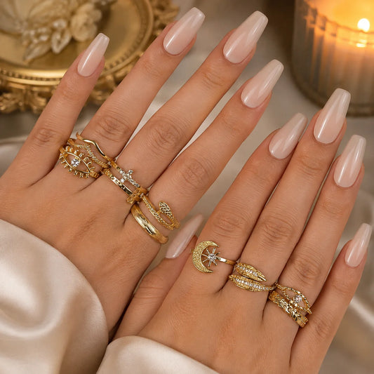 "Golden statement ring
 combo for women featuring celestial moon and star motifs, textured bands and contemporary stackable designs."

