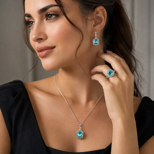 "Silver-tone turqoise blue crystal 
jewellery set featuring a blue gemstone pendant necklace, matching crystal drop earrings, and a coordinating statement ring. Elegant fashion jewellery set for women, perfect for weddings, parties, festive occasions, evening wear, and gifting."
