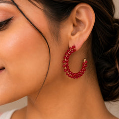 "Gold-tone hoop earrings 
wrapped with red 
crystal beads, creating a bold
 look that is perfect for  parties, 
weddings, and elegant 
everyday styling."
