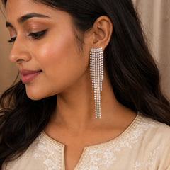 "Silver-tone crystal tassel drop earrings featuring cascading rhinestone strands with a sparkling waterfall design. Glamorous statement 
earrings for women, perfect 
for weddings, parties, festive occasions, and evening wear."
