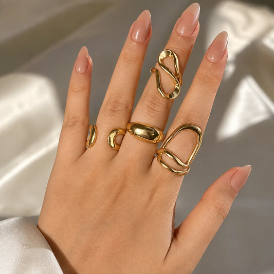 "Gold-tone adjustable 
ring combo set featuring four modern abstract statement rings with sculptural open designs and a polished finish. Minimalist fashion rings for women, perfect for everyday wear, stacking, parties, office wear, gifting, and contemporary styling."
