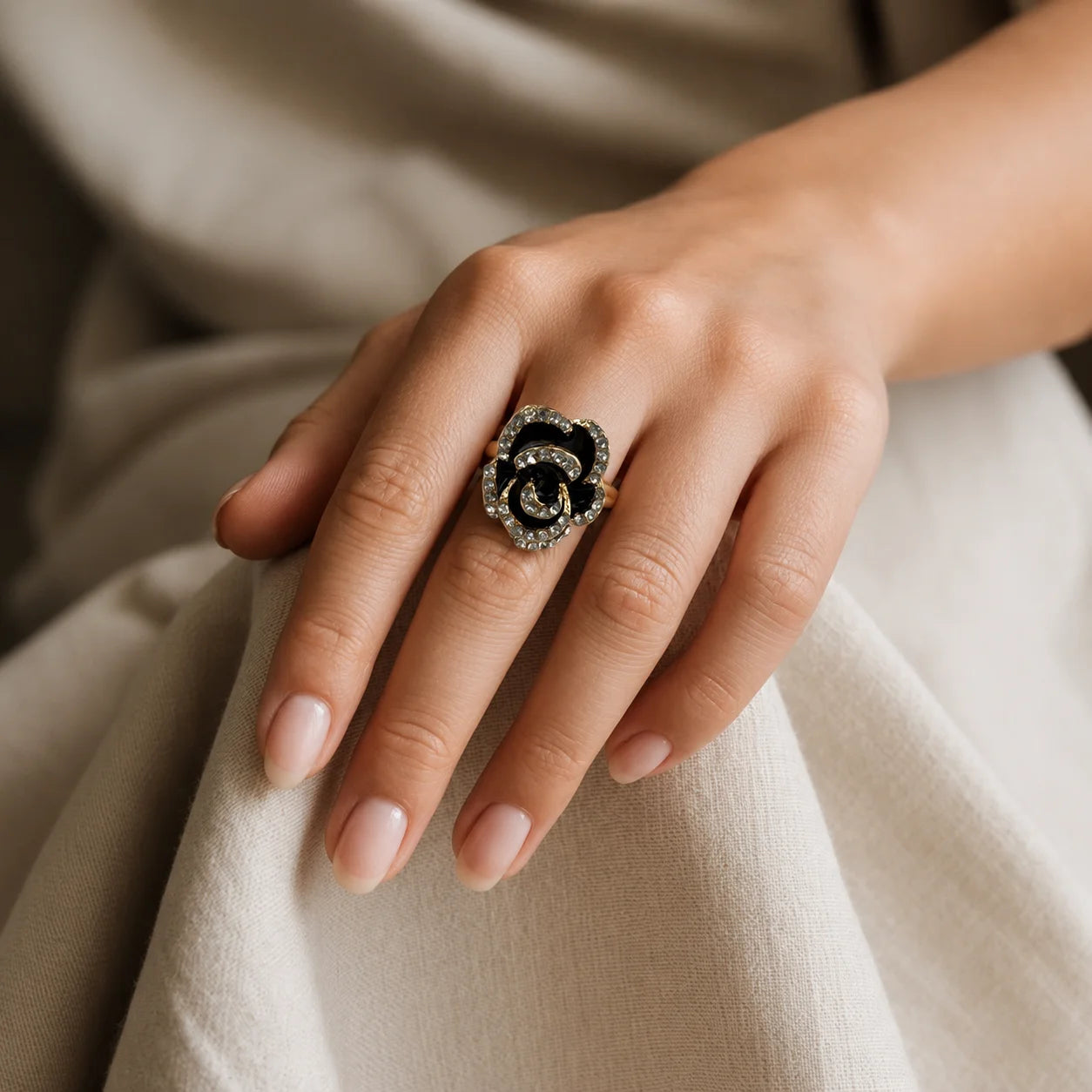 Black enamel rose statement ring with clear crystal pave on petals. Rose-gold tone adjustable band. Gothic romantic cocktail ring for women.
