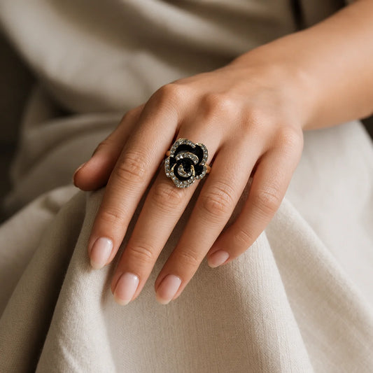 Black enamel rose statement ring with clear crystal pave on petals. Rose-gold tone adjustable band. Gothic romantic cocktail ring for women.
