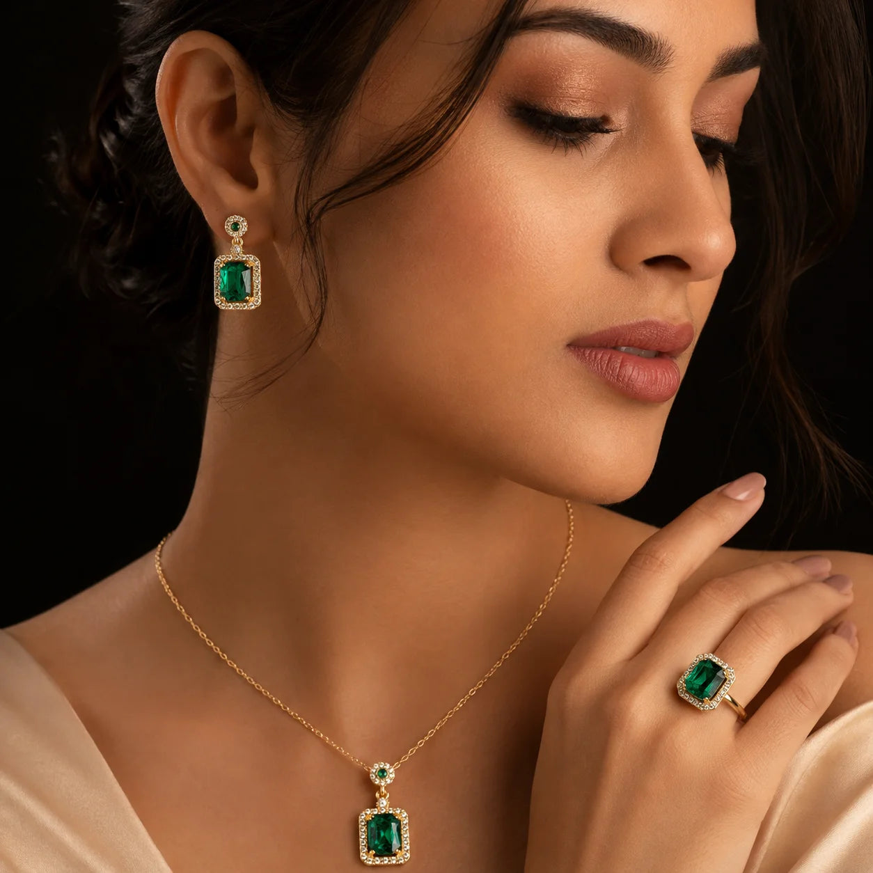 "Emerald green crystal jewellery
 set featuring a gold-tone pendant necklace, matching drop earrings, and a coordinating statement ring with sparkling clear stone accents, perfect for weddings, festive occasions, parties, and elegant evening wear."
