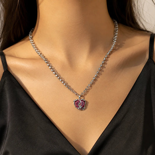 Silver-tone layered Y2K necklace with rhinestone tennis chain and pink iridescent heart pendant. Heart-link chain with crystal bow detail. Coquette jewellery.

