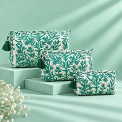 "Set of quilted fabric pouches 
with a white base and intricate green floral, leafy, and botanical prints, arranged in multiple sizes."
