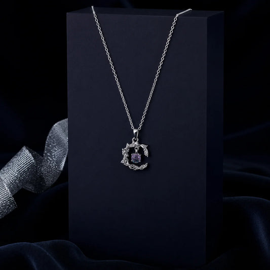 Silver-tone leaf pendant necklace with a shimmering lavender  crystal centerpiece, suspended from a delicate silver chain. Elegant and lightweight women's fashion jewellery for everyday and occasion wear.
