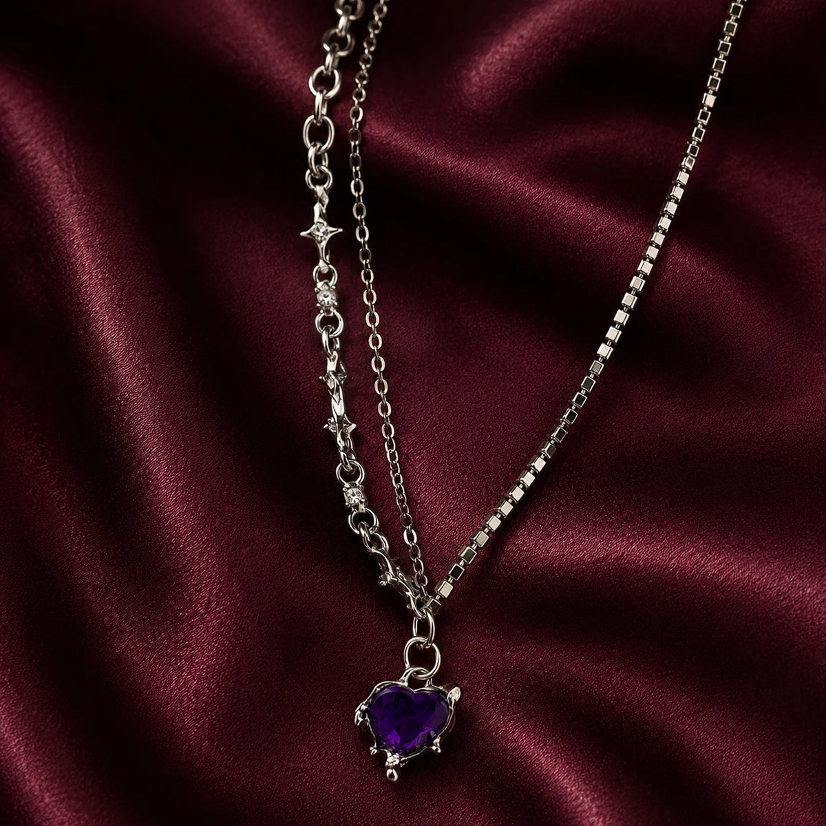 "Silver-tone layered 
necklace featuring sparkling rhinestone chains, star-link detailing, and a purple heart crystal 
pendant. Trendy Y2K-inspiredstatement jewellery for women, perfect for parties,
 concerts, and everyday fashion."
