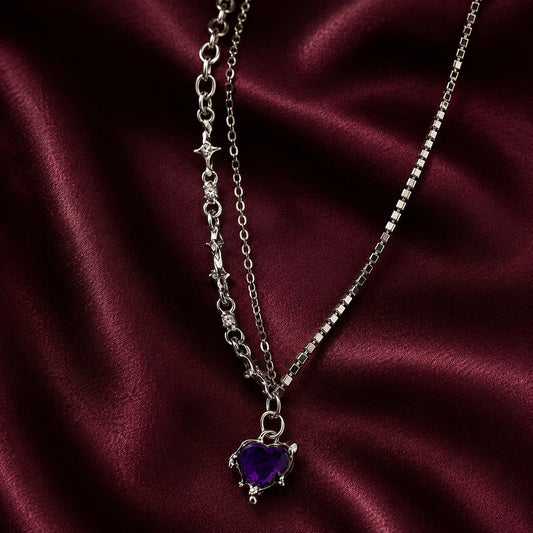 "Silver-tone layered 
necklace featuring sparkling rhinestone chains, star-link detailing, and a purple heart crystal 
pendant. Trendy Y2K-inspiredstatement jewellery for women, perfect for parties,
 concerts, and everyday fashion."
