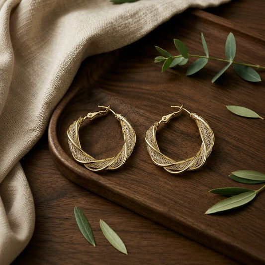 "Two-tone twisted hoop 
earrings featuring polished
 gold-tone curves and 
textured silver mesh
 detailing. Elegant
 lightweight statement 
hoop earrings for women,
 perfect for everyday wear
, office, parties, and 
festive occasions."
