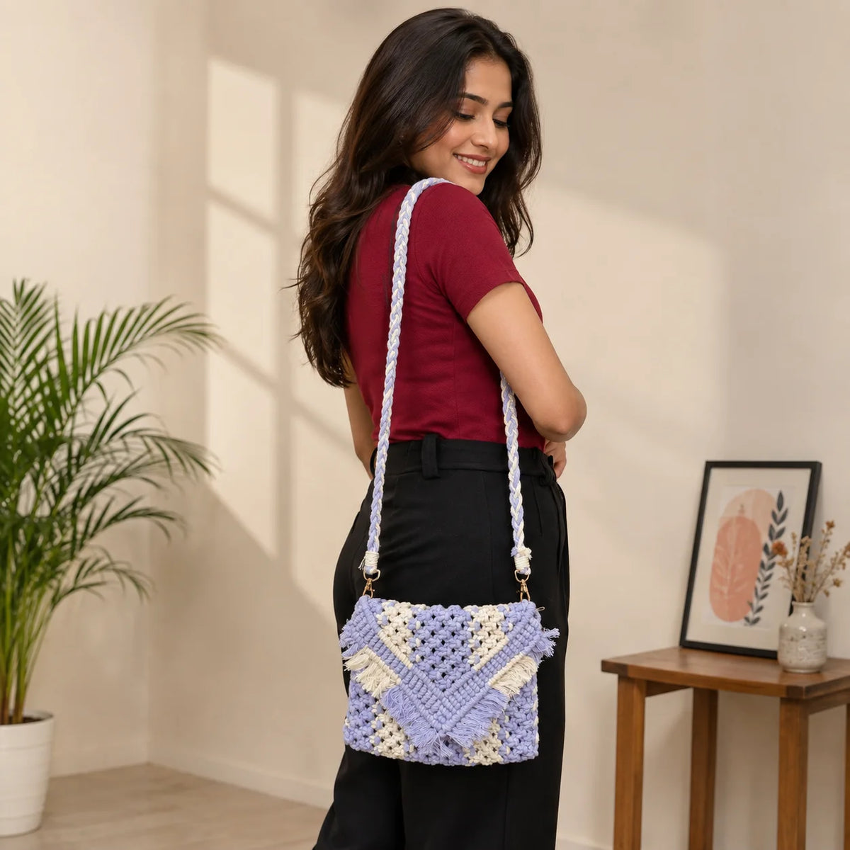 "Lavender and white macramé 
sling bag featuring an intricate woven pattern, envelope flap, and decorative fringe detailing."

