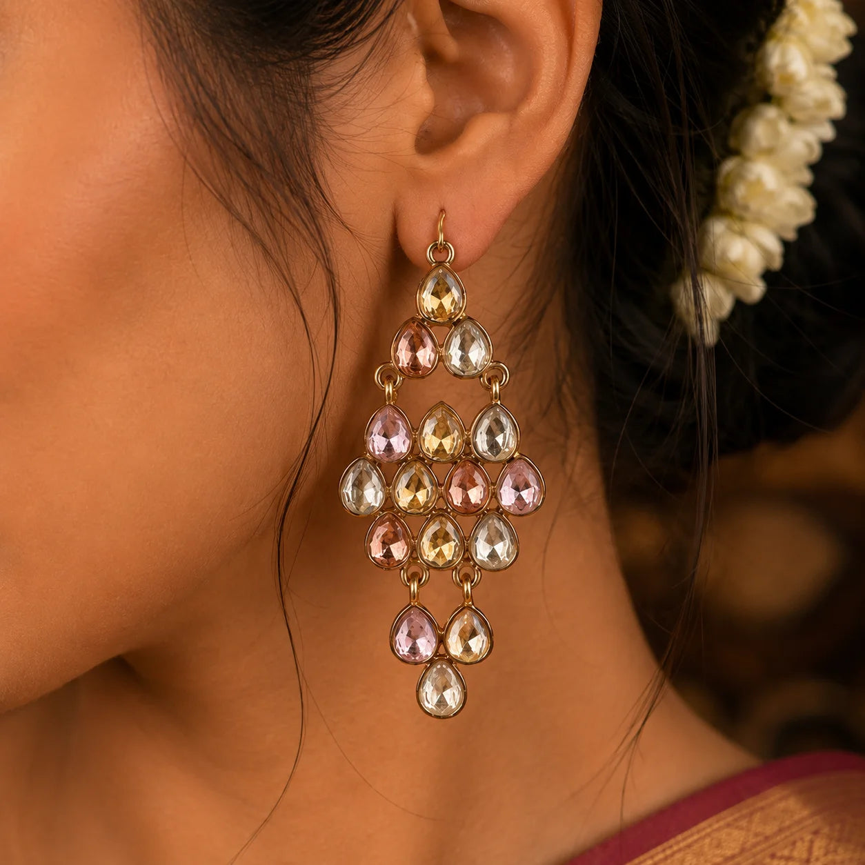 "Gold-tone Dangle earrings
 featuring sparkling teardrop-cut clear crystals in a cascading design, creating elegant statement earrings perfect for weddings, parties, festive occasions, and evening wear."
