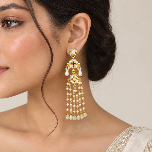 "Gold-toned pearl cascade kundan
 earrings featuring intricate white stone floral motifs, pearl accents, layered pearl chains, and teardrop pearl drops."
