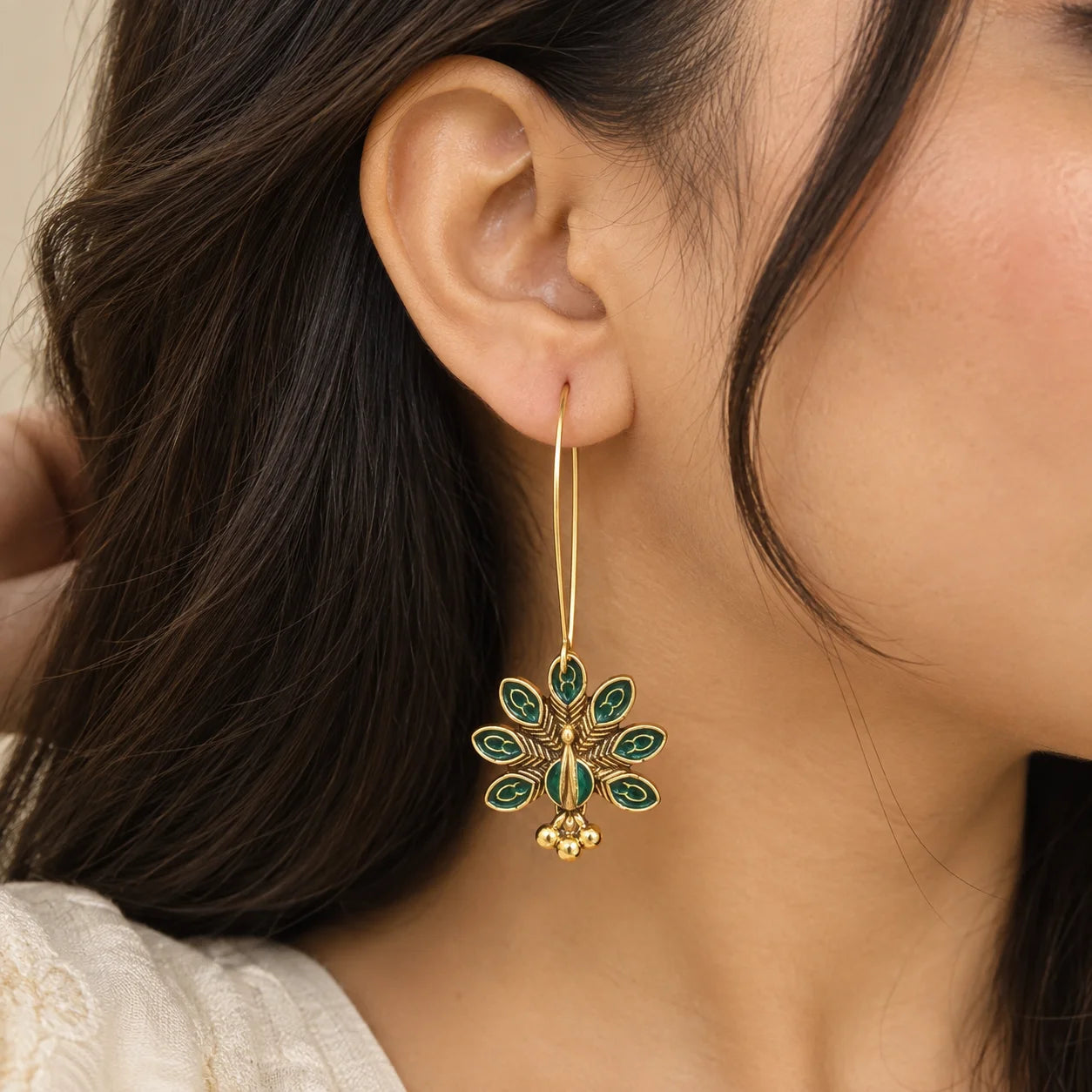 Emerald Peacock Hoop Earrings with intricate gold-tone detailing and small dangling bead charms.
