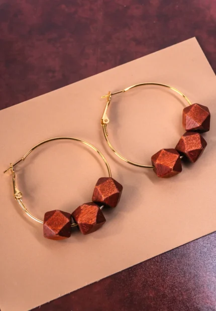 Chic metal hoop earrings featuring a wooden beads and a latch back for easy wear