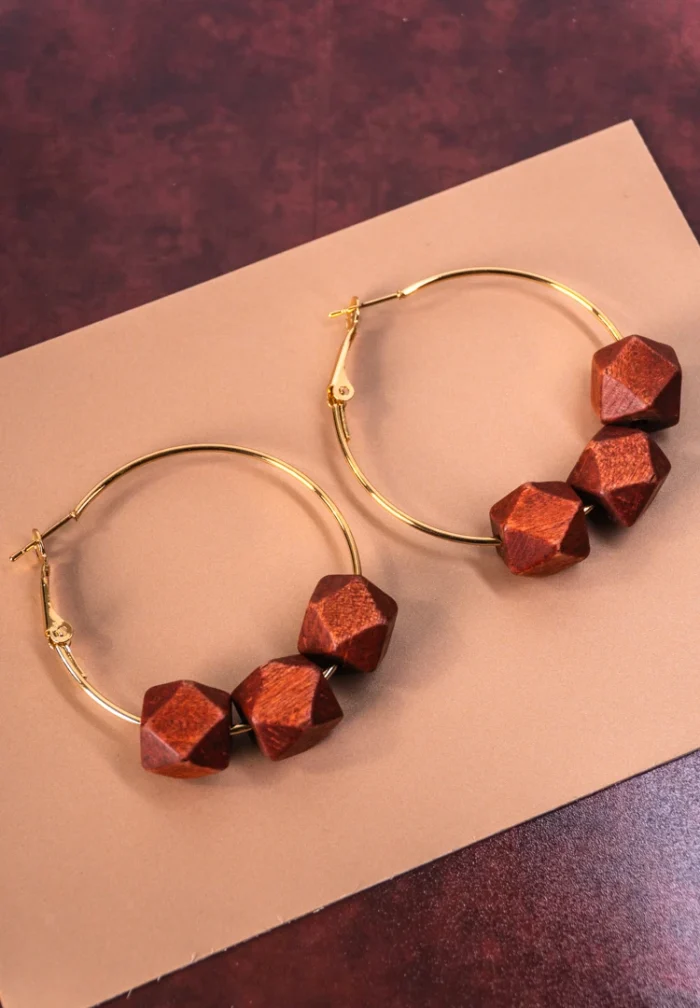 Chic metal hoop earrings featuring a wooden beads and a latch back for easy wear