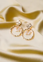 Chic metal hoop earrings featuring a polished gold-tone/pearl finish, playful golden hammered top , and a push back for easy wear