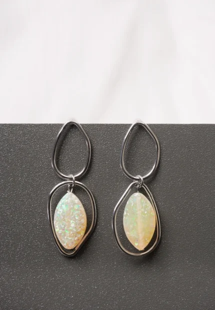Graceful silver-plated asymmetrical earrings showcasing a mesmerizing opal stone drop and an easy-to-wear push-back fastening