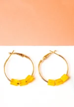 Chic metal hoop earrings featuring a polished golden-tone finish, playful three translucent yellow cube-shaped beads at the bottom , and a push back for easy wear.