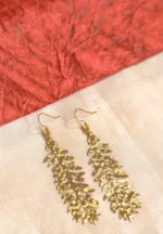 Sophisticated gold stud dangle earrings featuring a teardrop-shaped acrylic drop in a marbled blend of white and blue, secured with a push-back closure.