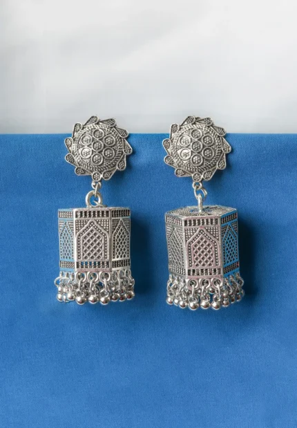 Lovely antique-finish oxidised metal jhumka earrings with a floral design, delicate dangling metallic beads, a classic hexagonal design, ghungroo at the end and a push-back closure