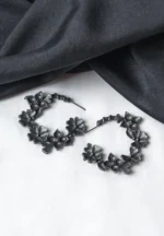 Intricately crafted oxidized C-hoop earring with floral detailing, offering a vintage charm, and finished with a push-back closure.
