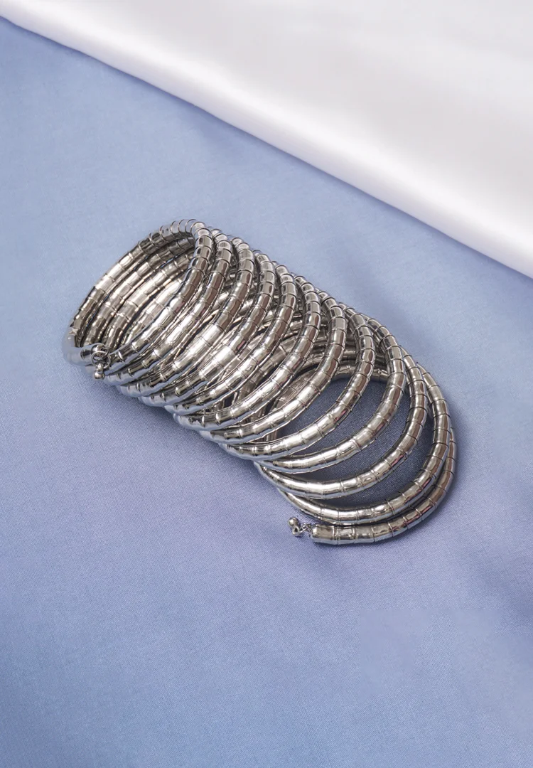 326-1 Contemporary metal spiral bracelet with a refined gold/silver texture, showcasing a multi-layered structure and bead details at both edges.