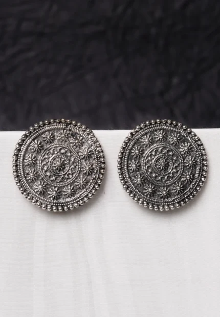 Vintage-inspired oxidized gold-tone circular dangle earring with a textured floral motif, flowing chain tassels, and a comfortable curved hook.