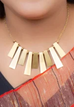 Stylish metal curb chain necklace with an organic-shaped pendant, enhanced with faceted blue teardrop stones, having a polished gold-tone finish, and a secure lobster claw clasp