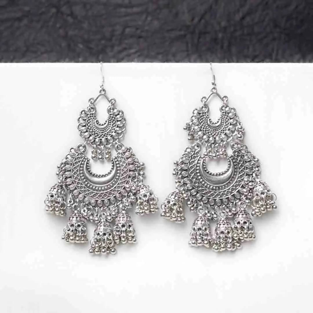 528-Th Fusion-style oxidised silver dangle earring featuring interconnected crescent elements, adorned with small jhumka-inspired details and ghungroos for a traditional touch, secured with a curved hook closure.