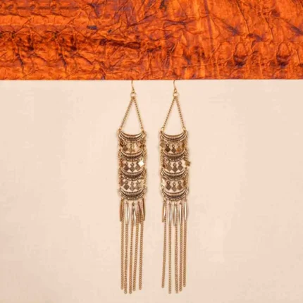 Chic bohemian-inspired metal dangle earrings featuring an antique gold/silver finish, crescent-shaped details, geometric charm accents, long chain tassels, and feather-like elements, completed with a curved hook closure