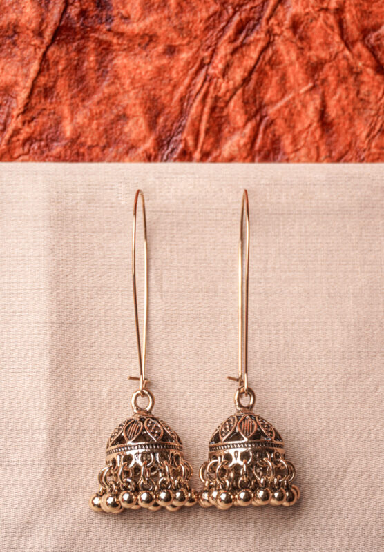 Lovely antique-finish metal chain jhumka earrings with a floral design, delicate dangling metallic beads, a classic dome-shaped design, and a push-back closure