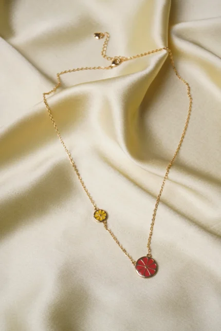 Stylish gold-tone necklace with a filled flat cable chain, lime yellow finish featuring enamel coated red coloured flower in the middle with a small yellow coloured flower , and a lobster claw clasp.