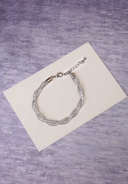 Refined and lightweight interwoven metal wire bracelet with shimmering crystals inside, secured with a lobster clasp for a secure fit.