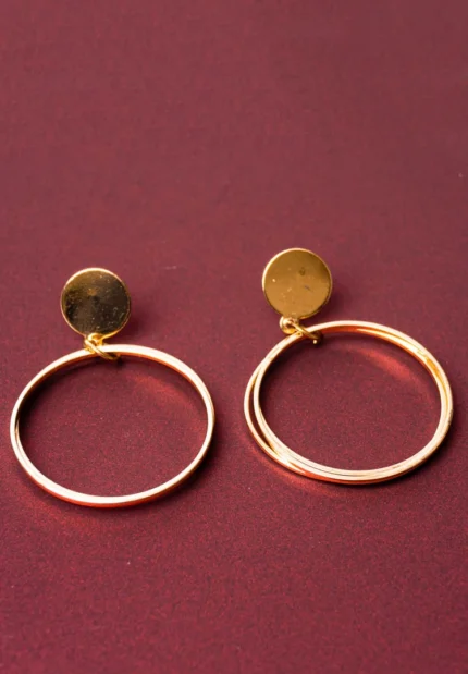 Chic metal hoop earrings featuring a dangling interconnected, and a push back for easy wear.