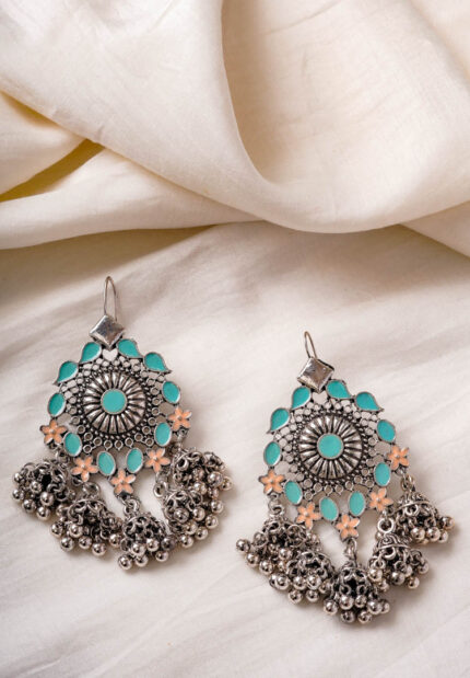Oxidised silver-tone dangle earrings with a geometric floral design, enhanced with turquoise and creme enamel detailing, also ghungroos at the bottom and a curved hook closure