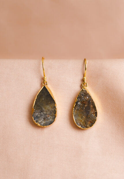 Chic teardrop-shaped metal drop earrings with a gold/moss green finish, showcasing a raw gemstone in an earthy gray and brown mix with a soft shimmer, and a curved hook closure